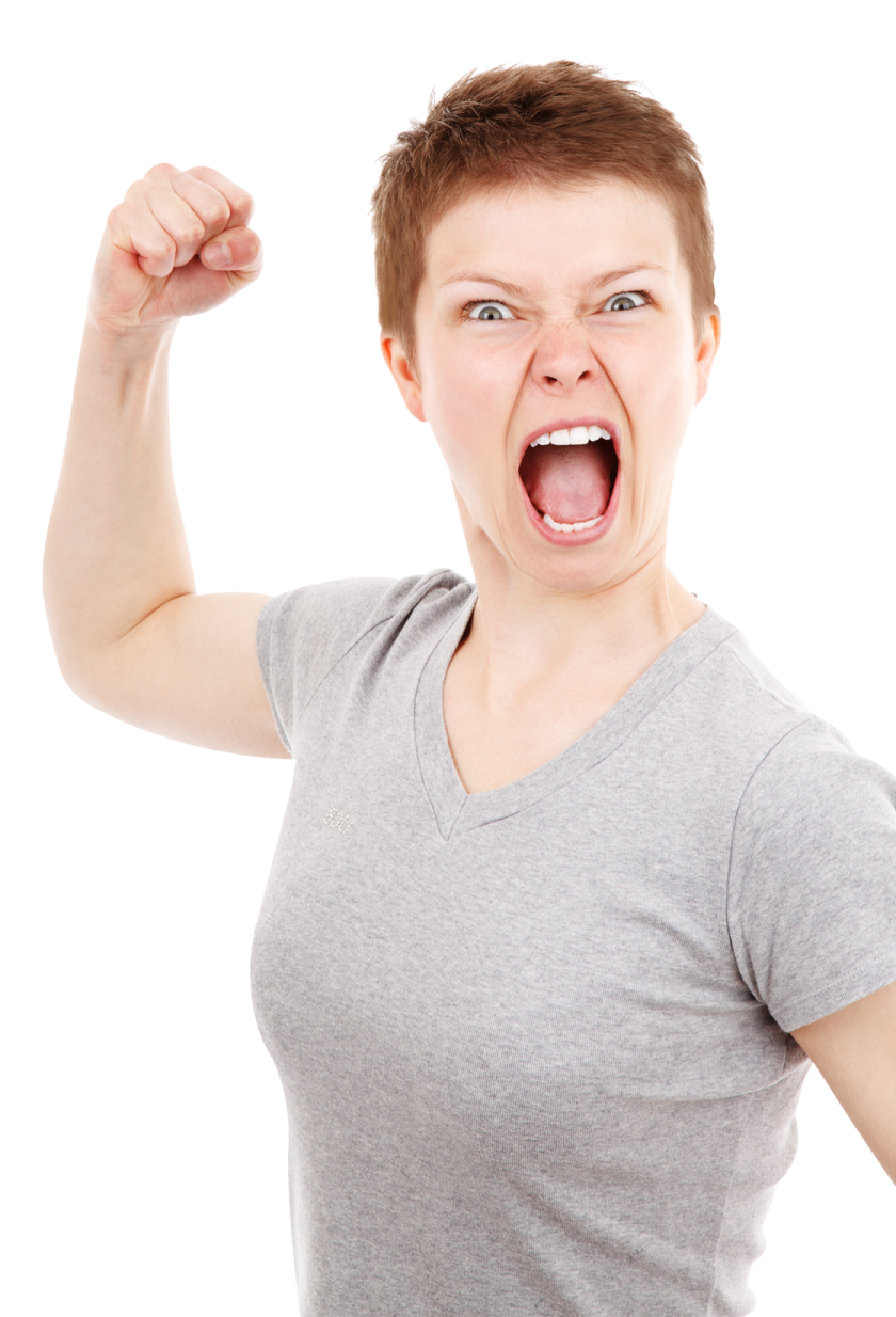 a woman in a gray shirt holding up her fist