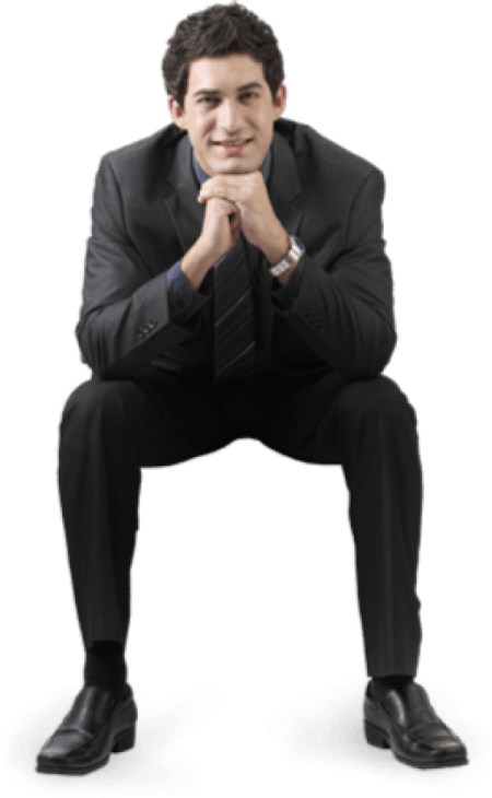a man in a suit and tie sitting on the ground