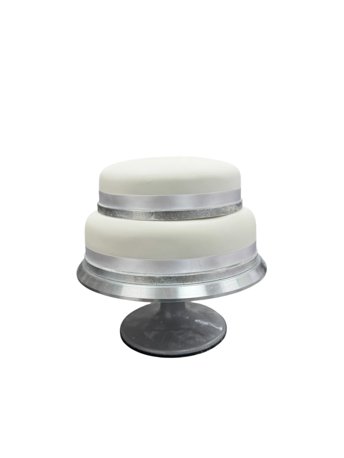 a white cake sitting on top of a metal stand