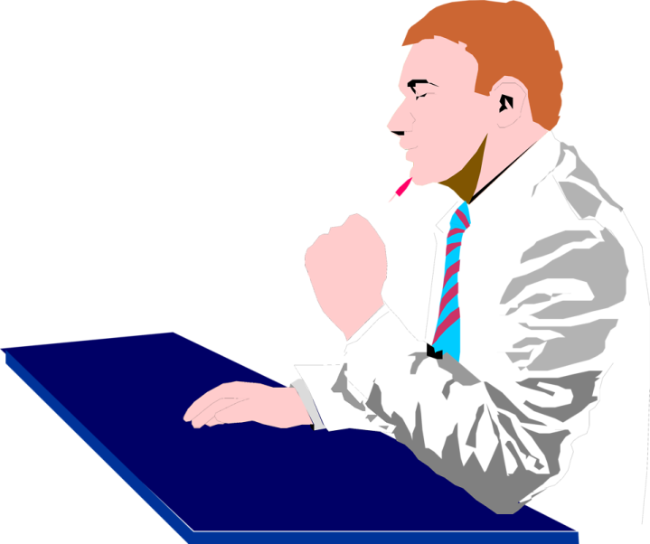 a man in a suit and tie sitting at a table