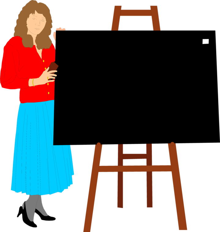 a woman standing in front of a blackboard
