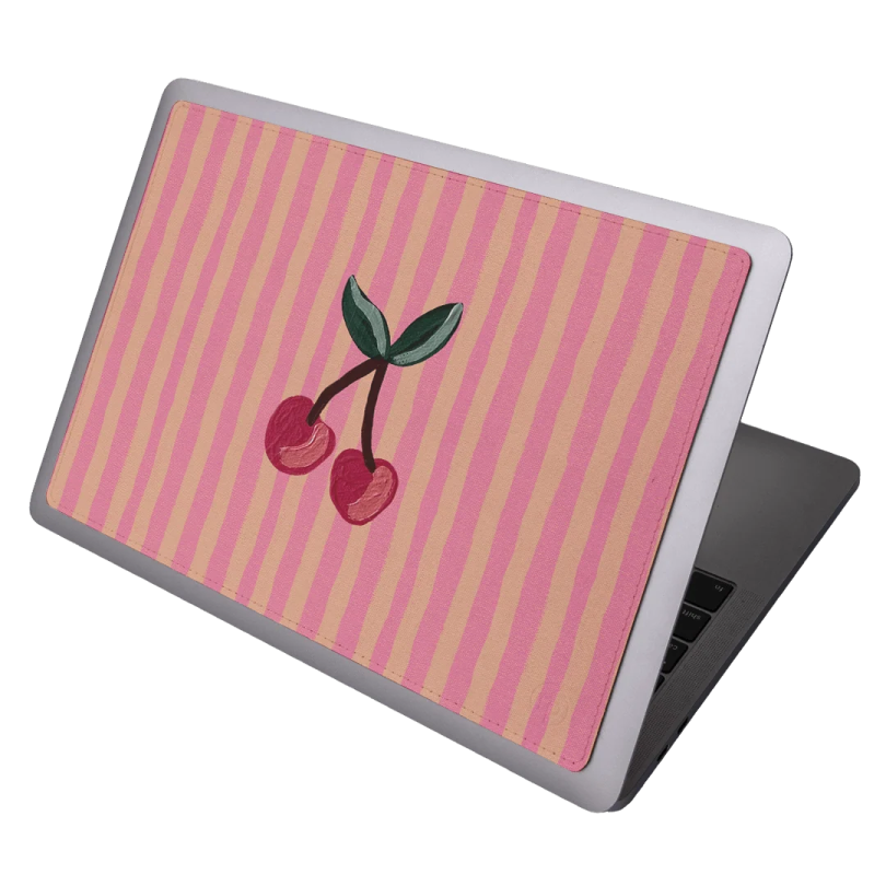 a laptop with a cherry on it