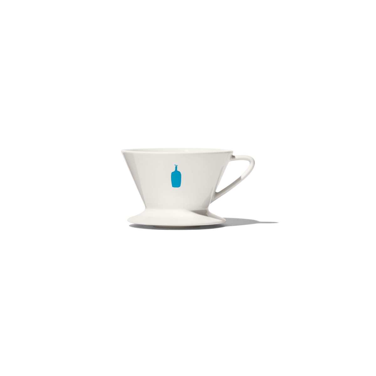 a white coffee cup with a blue handle