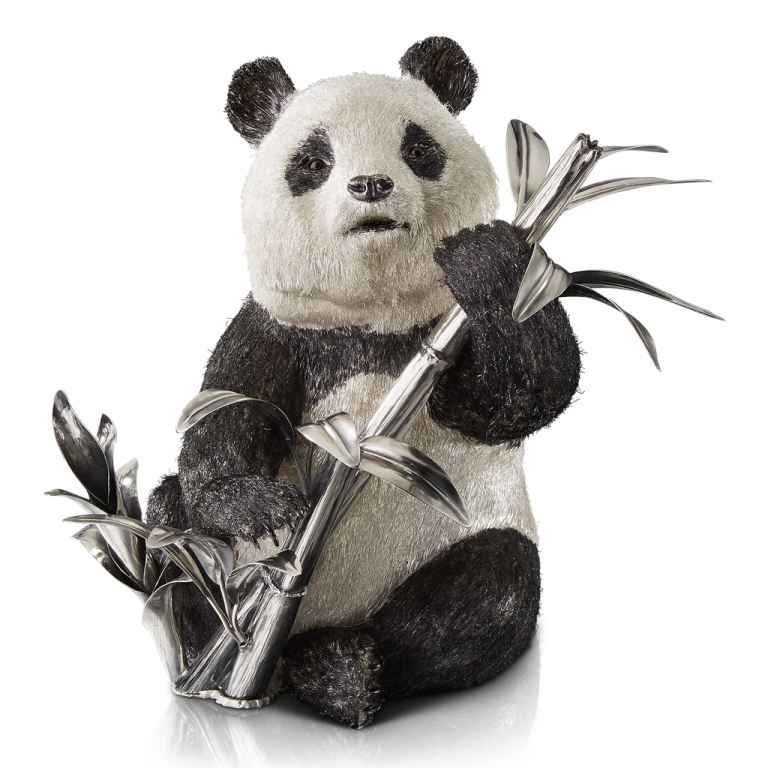 a stuffed panda bear holding a bamboo stick